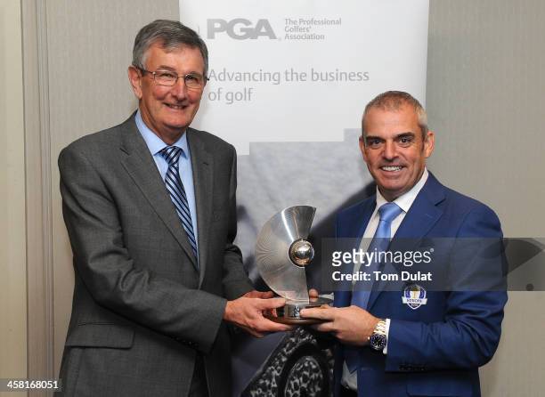 Paul McGinley receives the Recognition Award trophy from PGA captain Neil Selwyn-Smith during the PGA Lunch at The Grosvenor House Hotel on December...