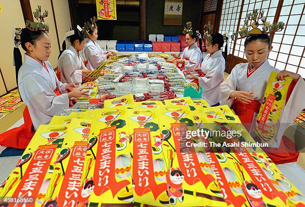 Shrine maidens pack 'Chitose Ame' candy in preparation for the Shichi-Go-San Festival at Sumiyoshi Taisha Shrine on October 31, 2014 in Osaka, Japan....
