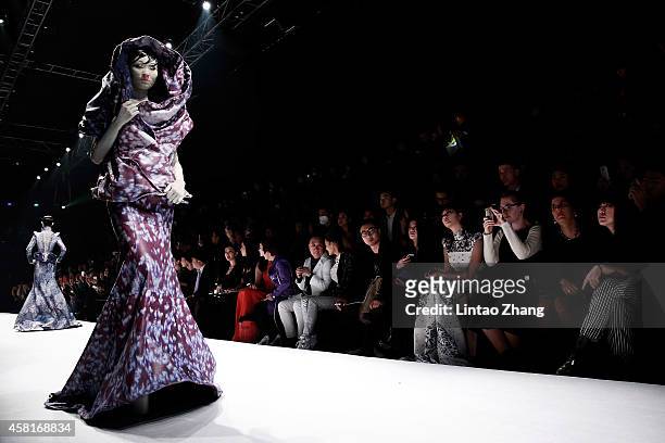 Model showcases designs on the runway at HEYUANCIYE Hu Sheguang Collection show during day seven of Mercedes-Benz China Fashion Week Spring/Summer...