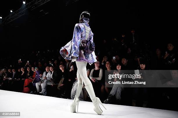 Model showcases designs on the runway at HEYUANCIYE Hu Sheguang Collection show during day seven of Mercedes-Benz China Fashion Week Spring/Summer...