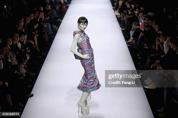 Model showcases designs on the runway at Hu Sheguang Collection show during Mercedes-Benz China Fashion Week Spring/Summer 2015 at Beijing Hotel on...