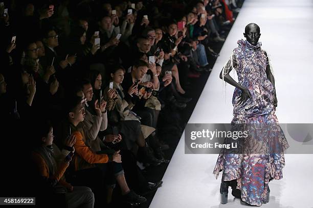 Model showcases designs on the runway at Hu Sheguang Collection show during Mercedes-Benz China Fashion Week Spring/Summer 2015 at Beijing Hotel on...