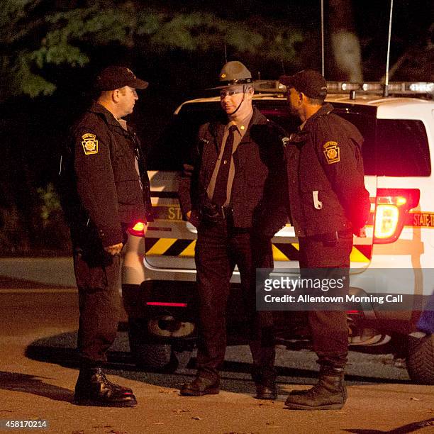 Pennsylvania State Troopers wait outside the Blooming Grove Township Building on Thursday, Oct. 30 hours after Eric Frein was apprehended at an...