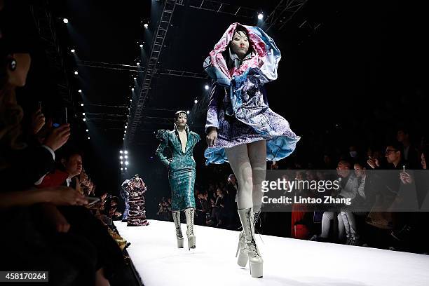 Models showcases designs on the runway at HEYUANCIYE Hu Sheguang Collection show during day seven of Mercedes-Benz China Fashion Week Spring/Summer...