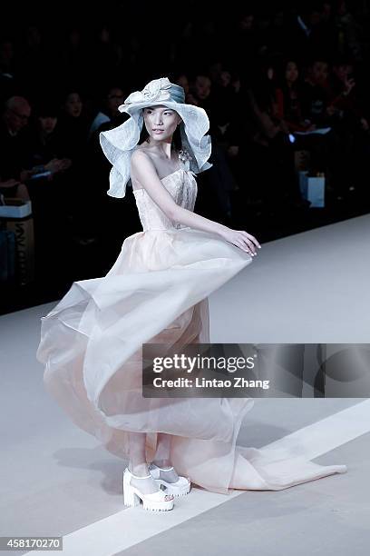 Model showcases designs on the runway at HUI Zhao Huizhou Collection show during day seven of Mercedes-Benz China Fashion Week Spring/Summer 2015 at...