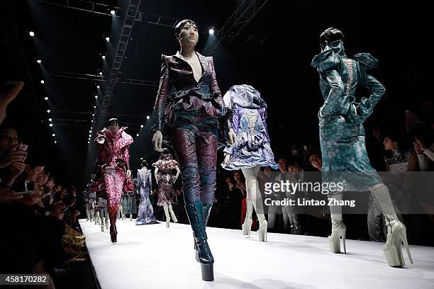 Models showcases designs on the runway at HEYUANCIYE Hu Sheguang Collection show during day seven of Mercedes-Benz China Fashion Week Spring/Summer...