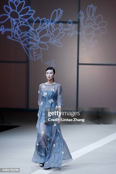 Model showcases designs on the runway at HUI Zhao Huizhou Collection show during day seven of Mercedes-Benz China Fashion Week Spring/Summer 2015 at...