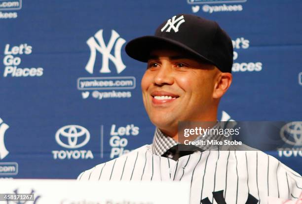 Outfielder Carlos Beltran speaks to the media during his introductory press conference at Yankee Stadium on December 20, 2013 in the Bronx borough of...