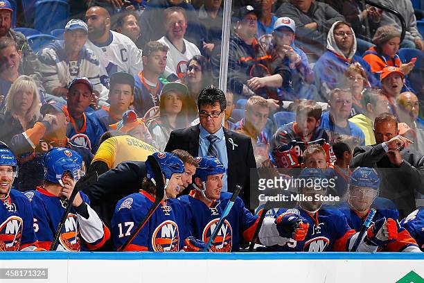 Jack Capuano of the New York Islanders looks on from the bench against the Toronto Maple Leafs at Nassau Veterans Memorial Coliseum on October 21,...