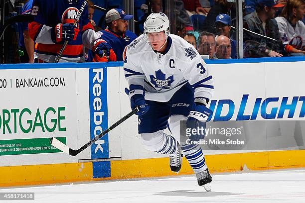 Dion Phaneuf of the Toronto Maple Leafs skates against the New York Islanders at Nassau Veterans Memorial Coliseum on October 21, 2014 in Uniondale,...
