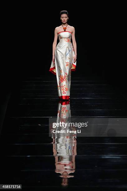 Model showcases designs on the runway at Watermark Deng Zhaoping Collection show during Mercedes-Benz China Fashion Week Spring/Summer 2015 at...