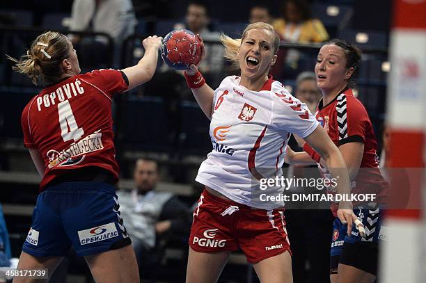 Polands Karolina Siodmiak vies with Serbia's Sanja Damnjanovic and Serbia's Jelena Popovic during the Women's Handball World Championship semi final...