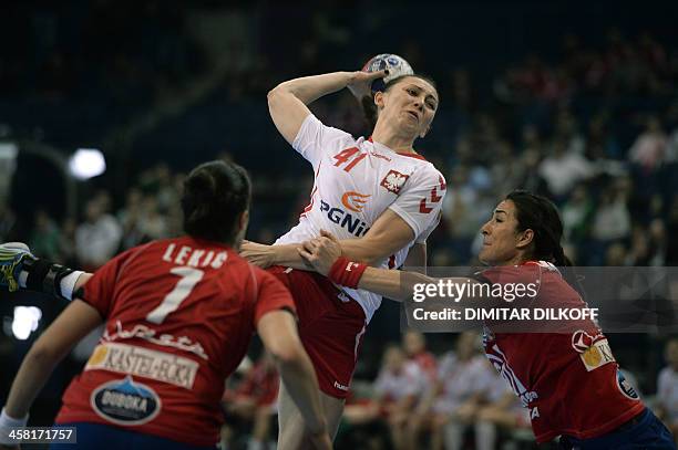 Polands Malgorzata vies with Serbia's Andrea Lekic and Serbia's Sanja Damnjanovic during the Women's Handball World Championship semi final match...