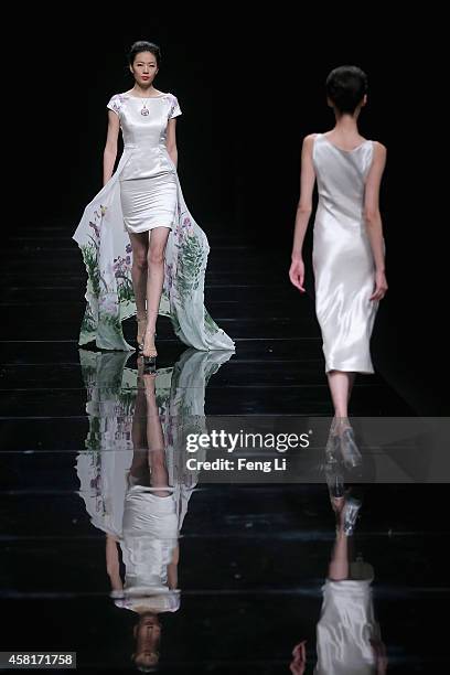 Models showcase designs on the runway at Watermark Deng Zhaoping Collection show during Mercedes-Benz China Fashion Week Spring/Summer 2015 at...