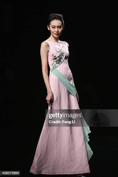 Model showcases designs on the runway at Watermark Deng Zhaoping Collection show during Mercedes-Benz China Fashion Week Spring/Summer 2015 at...