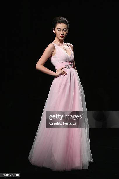 Model showcases designs on the runway at Watermark Deng Zhaoping Collection show during Mercedes-Benz China Fashion Week Spring/Summer 2015 at...