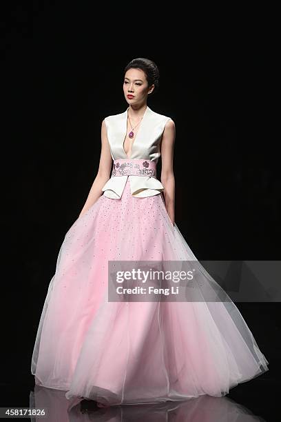 Model showcases designs on the runway at Watermark Deng Zhaoping Collection show during Mercedes-Benz China Fashion Week Spring/Summer 2015 at...