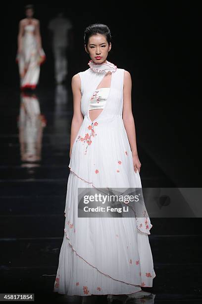 Model showcases designs on the runway at Watermark Deng Zhaoping Collection show during Mercedes-Benz China Fashion Week Spring/Summer 2015 at...