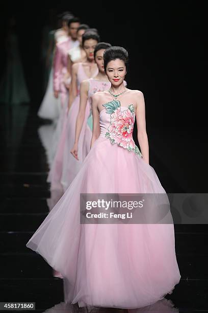 Models showcase designs on the runway at Watermark Deng Zhaoping Collection show during Mercedes-Benz China Fashion Week Spring/Summer 2015 at...