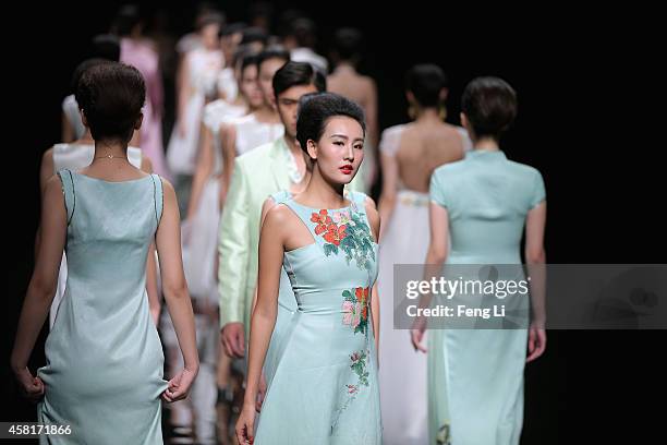 Models showcase designs on the runway at Watermark Deng Zhaoping Collection show during Mercedes-Benz China Fashion Week Spring/Summer 2015 at...