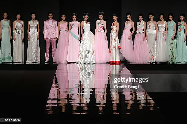 Models showcase designs on the runway at Watermark Deng Zhaoping Collection show during Mercedes-Benz China Fashion Week Spring/Summer 2015 at...