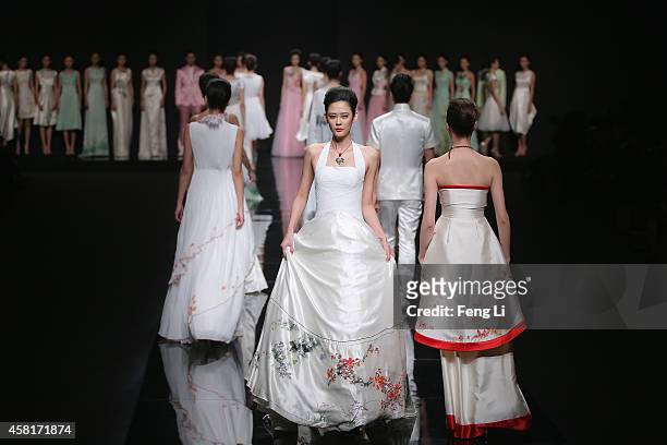 Models showcase designs on the runway at Watermark Deng Zhaoping Collection show during Mercedes-Benz China Fashion Week Spring/Summer 2015 at...