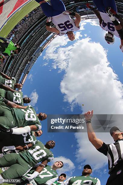 Referee Gene Steratore performs the coin toss with the captains of the New York Jets and the Buffalo Bills at MetLife Stadium on October 26, 2014 in...