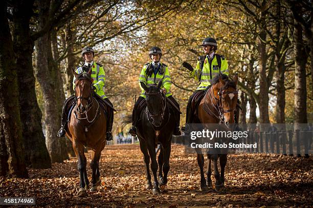 Mounted police officers ride through Green Park on October 31, 2014 in London, England. Temperatures in London are forecasted to exceed 20 degrees...