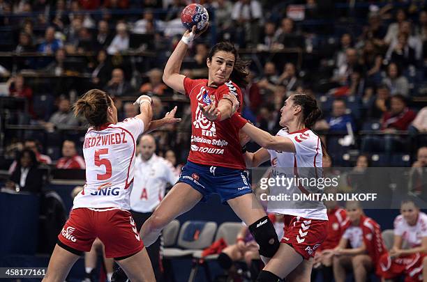 Serbia's Sanja Damnjanovic challenges Poland's Iwona Niedzwiedz and Karolina Semeniuk-Olchawa during the 2013 Women's Handball World Championship...