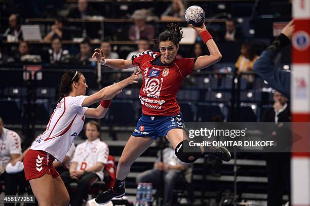 Serbia's Sanja Damnjanovic challenges Polands Katarzyna Koniuszaniec during the 2013 Women's Handball World Championship semi-final match between...