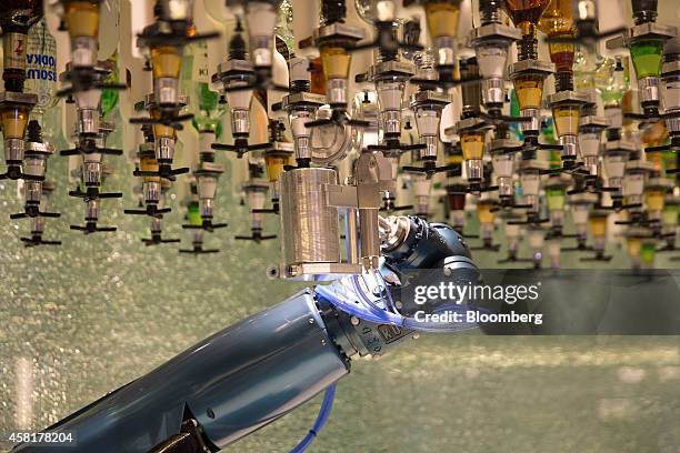 Robotic arm selects a shot of alcohol as it prepares a drink for a guest at the Bionic Bar onboard the Quantum of the Seas cruise ship, operated by...