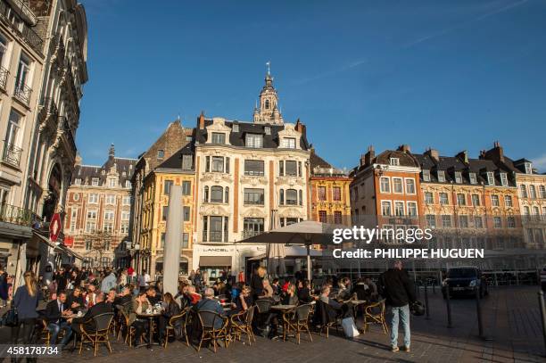 People sit at a cafe in La Grand Place of the northern French city of Lille, on October 30, 2014. Lille is the fourth-largest metropolitan area in...