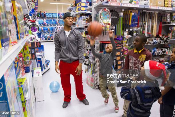 Damian Lillard of the Portland Trail Blazers shoots hoops with kids during a Christmas shopping spree he hosted for the the Blazers Boys and Girls...