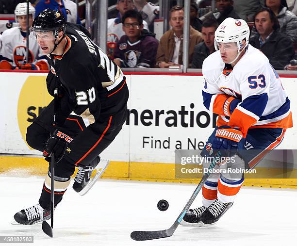 Casey Cizikas of the New York Islanders battles for the puck against David Steckel of the Anaheim Ducks on December 9, 2013 at Honda Center in...