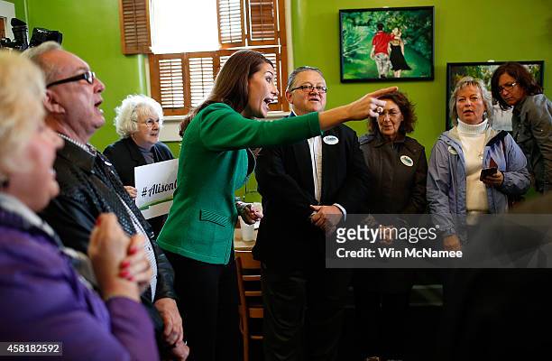 Democratic Senate candidate and Kentucky Secretary of State Alison Lundergan Grimes speaks to supporters inside Buddy's Pizza during a campaign stop...