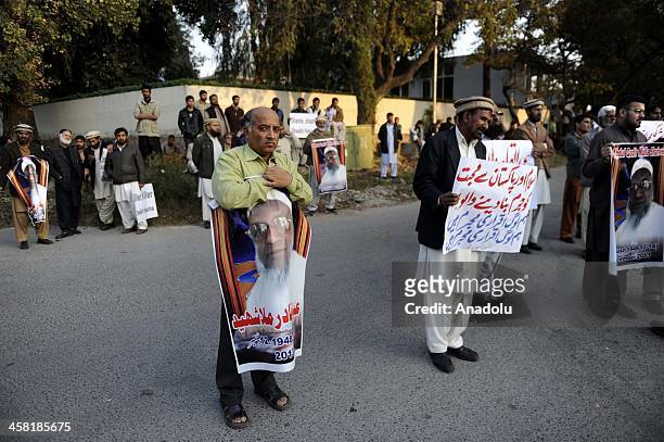 Members of Jamaat-e-Islami Pakistan hold placards during a protest outside the Bangladesh high commission to condemn the execution of Bangladesh...
