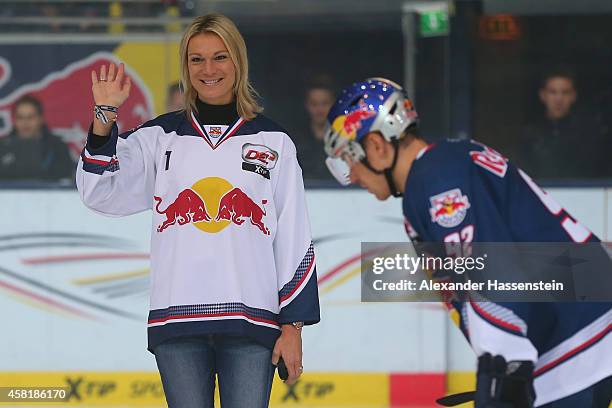 Maria Hoefl-Riesch opens the first bully next to Alexander Barta of Muenchen for the DEL Ice Hockey match between EHC Red Bull Muenchen and Krefeld...