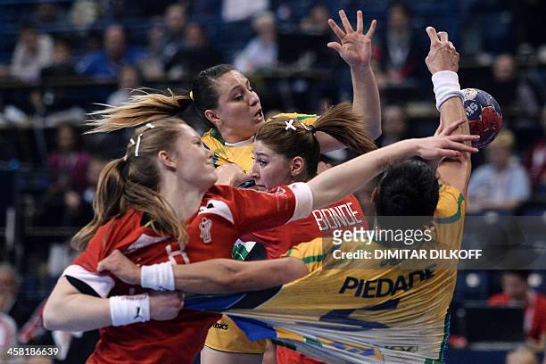 Denmarks Anne Mette and Denmarks Marianne Bonde Pedersen vie with Brazils Daniela Piedade during the Women's Handball World Championship semi final...