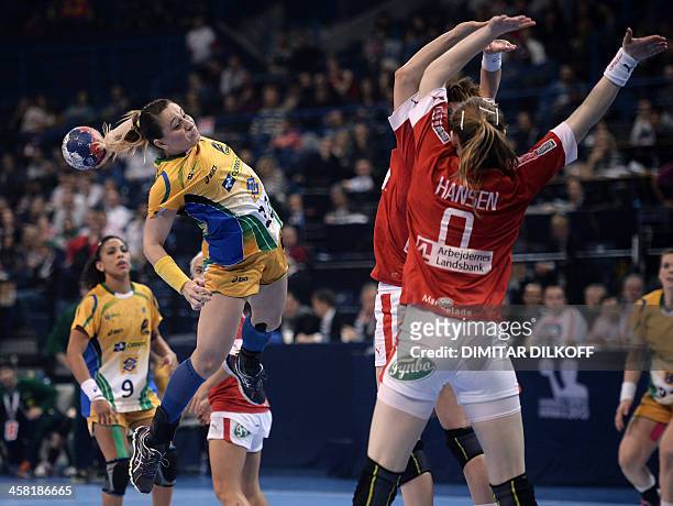 Brazils Mayara Moura vies with Denmarks Marianne Bonde Pedersen and Denmarks Anne Mette during the Women's Handball World Championship semi final...