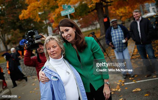 Democratic Senate candidate and Kentucky Secretary of State Alison Lundergan Grimes greets supporters outside Buddy's Pizza before a campaign stop...