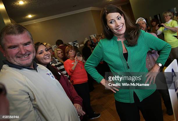 Democratic Senate candidate and Kentucky Secretary of State Alison Lundergan Grimes talks with supporters inside Purdy's Coffee during a campaign...