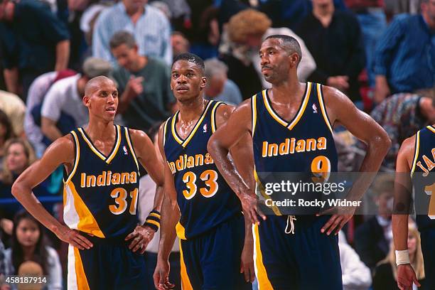 Derrick McKey, Reggie Miller and Antonio Davis of the Indiana Pacers stand against the Sacramento Kings on November 30, 1995 at Arco Arena in...