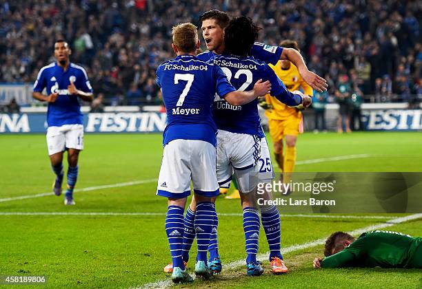 Klaas Jan Huntelaar of Schalke 04 celebrates with Atsuto Uchida of Schalke 04 and Max Meyer of Schalke 04 after scoring his teams first goal during...