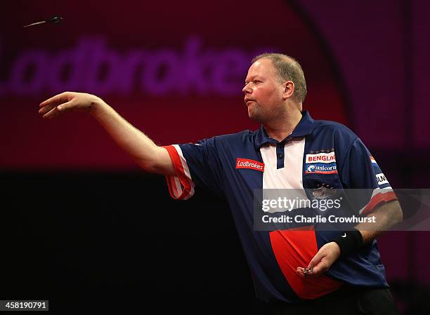 Raymond Van Barneveld of Holland throws during his second round match against Jamie Caven of England during the Ladbrokes.com World Darts...