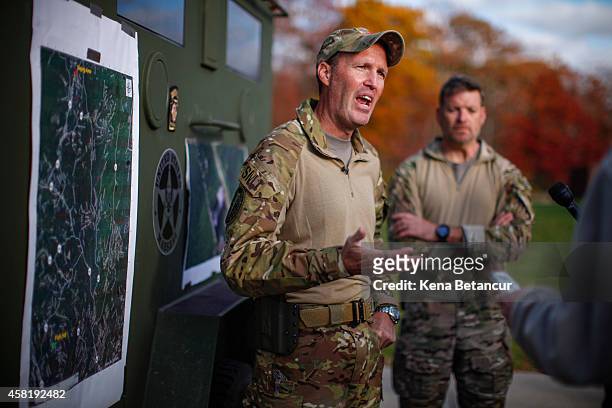 Scott Malkowski, Task Force Commander, US Marshals Service, Special Operations Group, talks with members of the media while he explains how Eric...