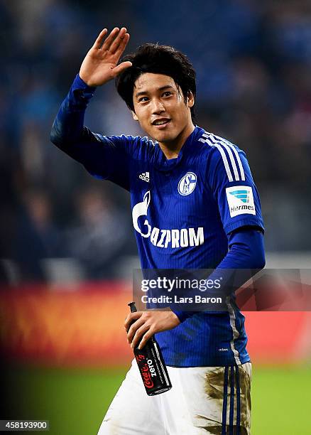 Atsuto Uchida of Schalke 04 celebrates with the fans after winning the Bundesliga match between FC Schalke 04 and FC Augsburg at Veltins Arena on...