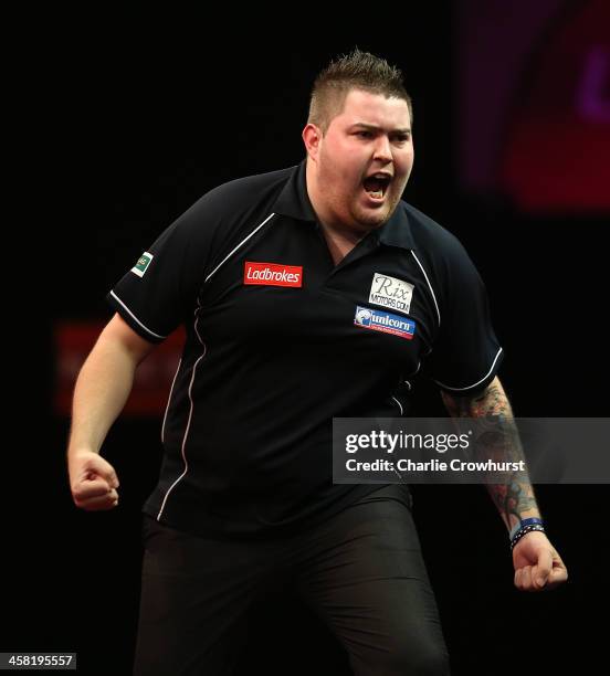 Michael Smith of England celebrates after winning his second round match against Phil Taylor of England during the Ladbrokes.com World Darts...