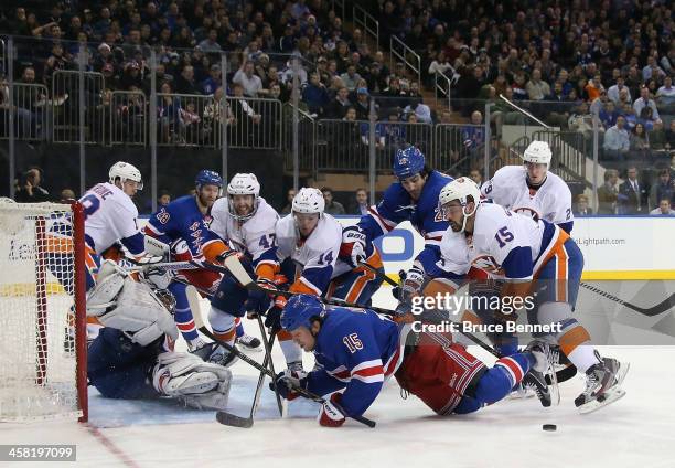 Cal Clutterbuck of the New York Islanders takes a two minute penalty for crosschecking Derek Dorsett of the New York Rangers during the second period...