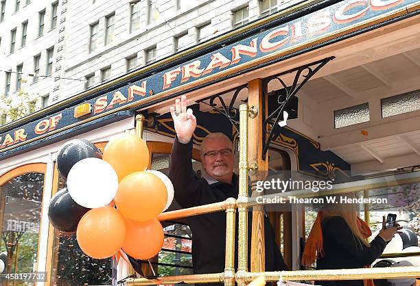 General manager Brian Sabean of the San Francisco Giants waves to the crowd along the parade route during the San Francisco Giants World Series...