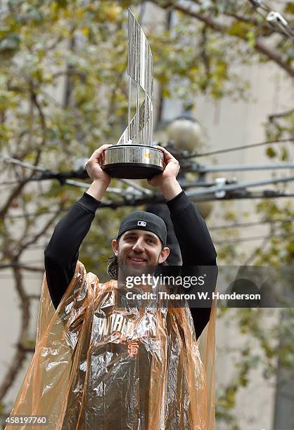 World Series MVP Madison Bumgarner of the San Francisco Giants, shows his MVP trophy to the crowd along the parade route during the San Francisco...